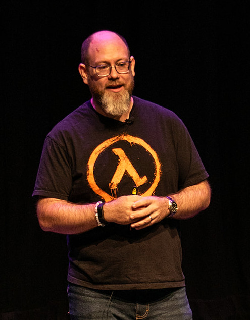 Stuart Thomas presenting on stage at TestBash / Motacon 2025